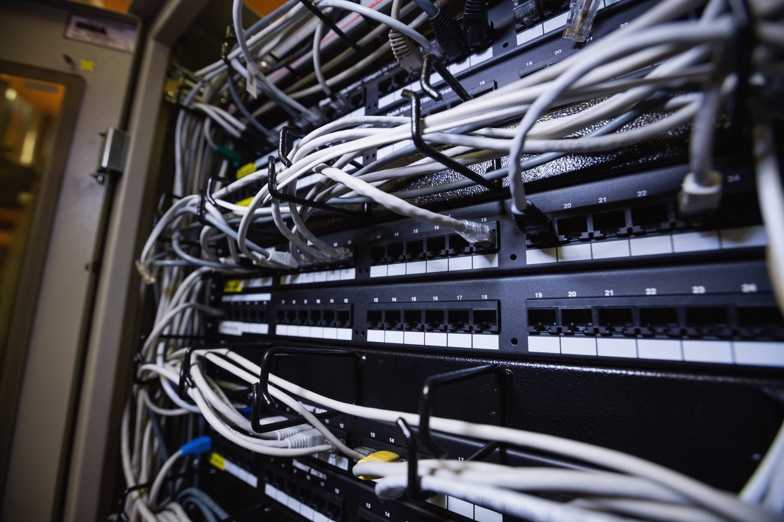 Network cabinet and patch panel in an Oshawa business. Wi-Fi, switching, and cabling from Full Spectrum Computer Services.